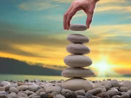 stones built on top of each other by hand with sunset in background